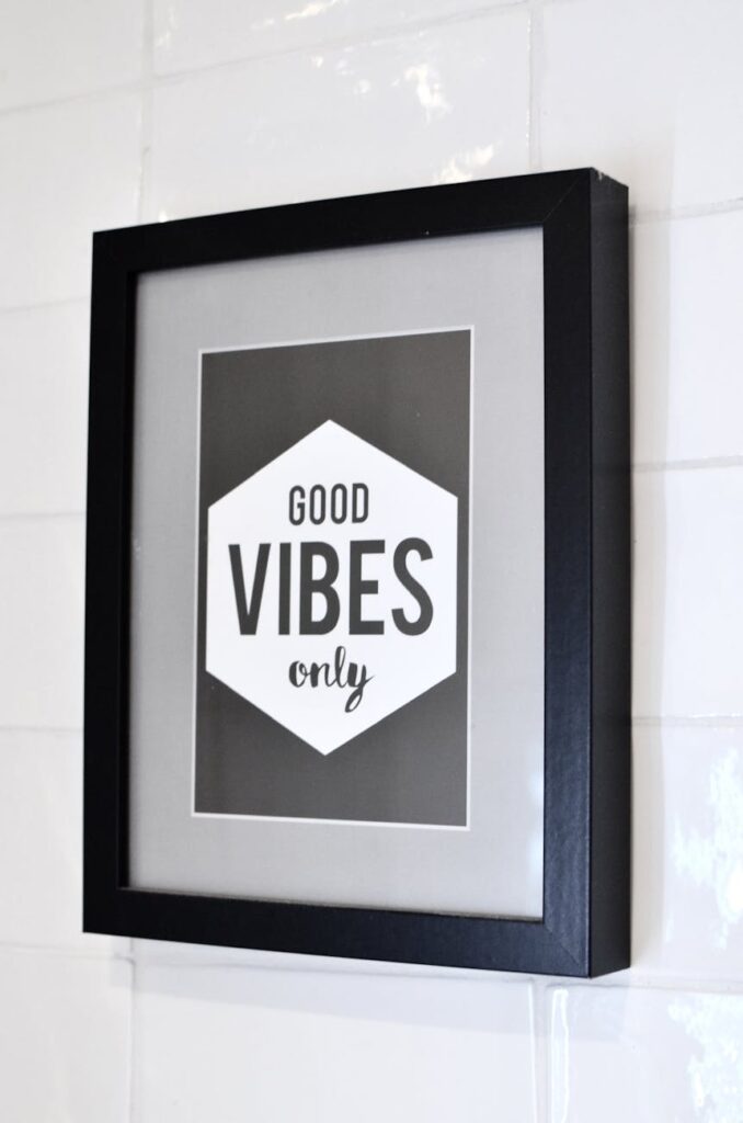 framed picture with inspirational text hanging on wall
