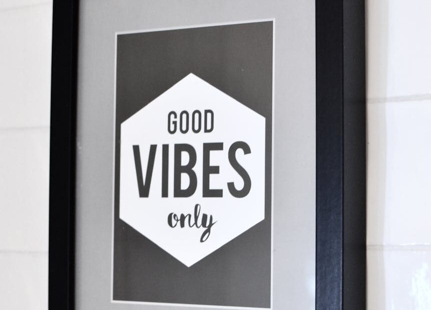 framed picture with inspirational text hanging on wall